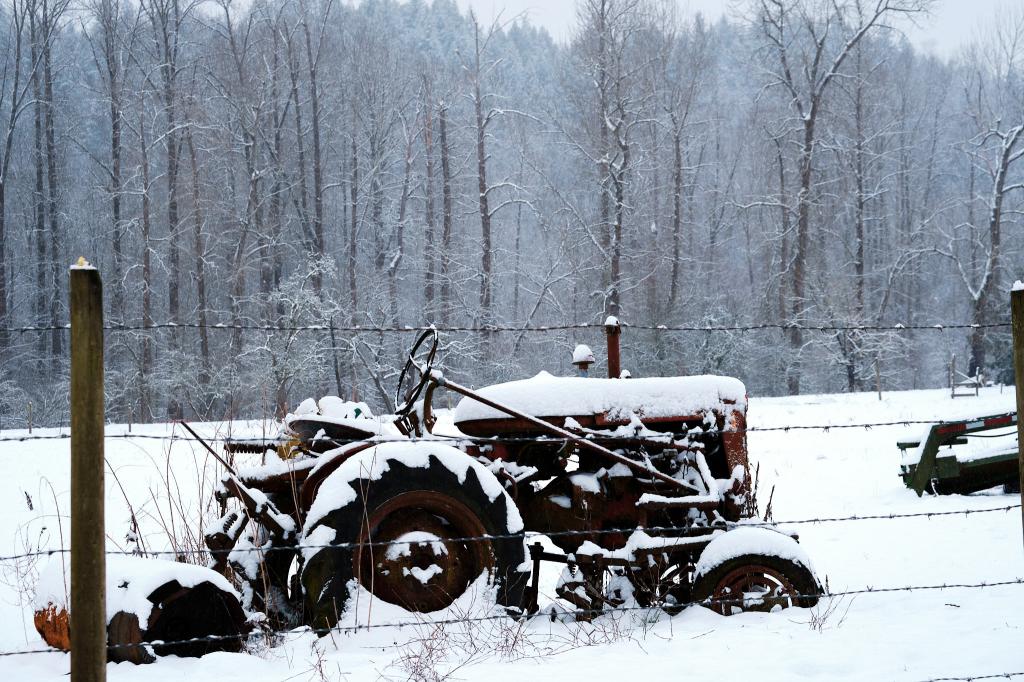 An image of a tractor covered in snow.
